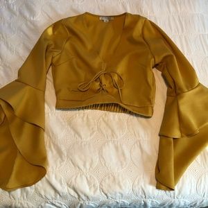 Mustard crop top with flounce sleeves.